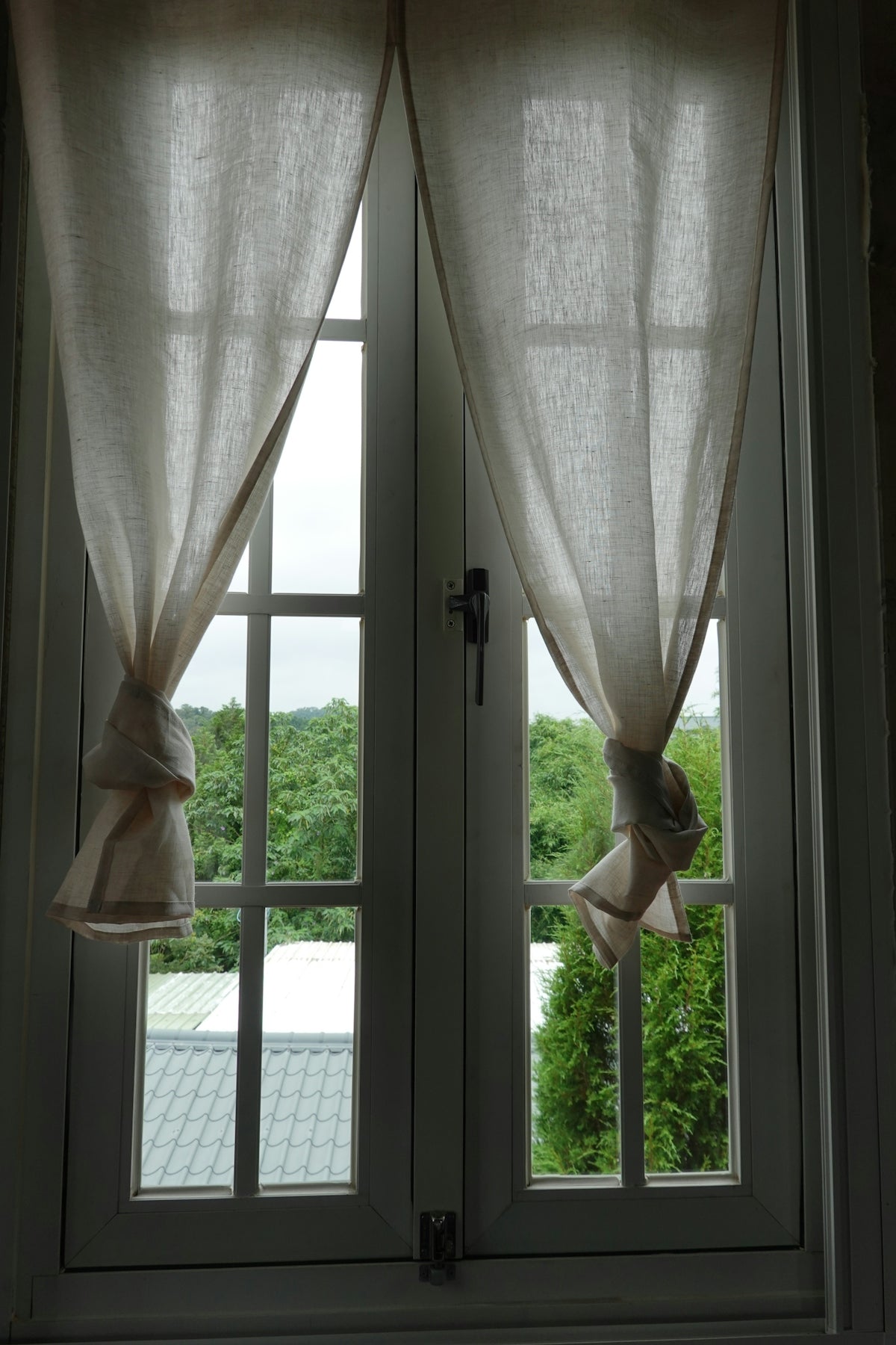 a pair of curtains hanging from the side of a window
